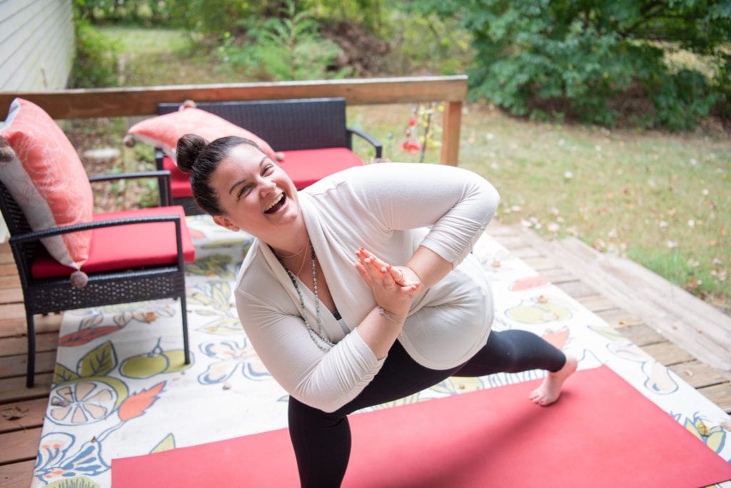 A woman doing a yoga pose outdoor.