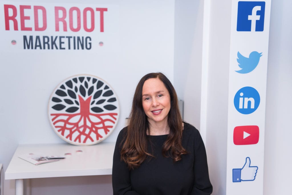 Owner of Red Root Marketing located in Verona, New Jersey in her office.