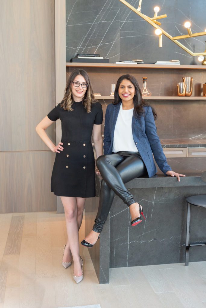 Two female family and divorce attorneys posing for their branding photoshoot in a New York City luxury condo's event space.