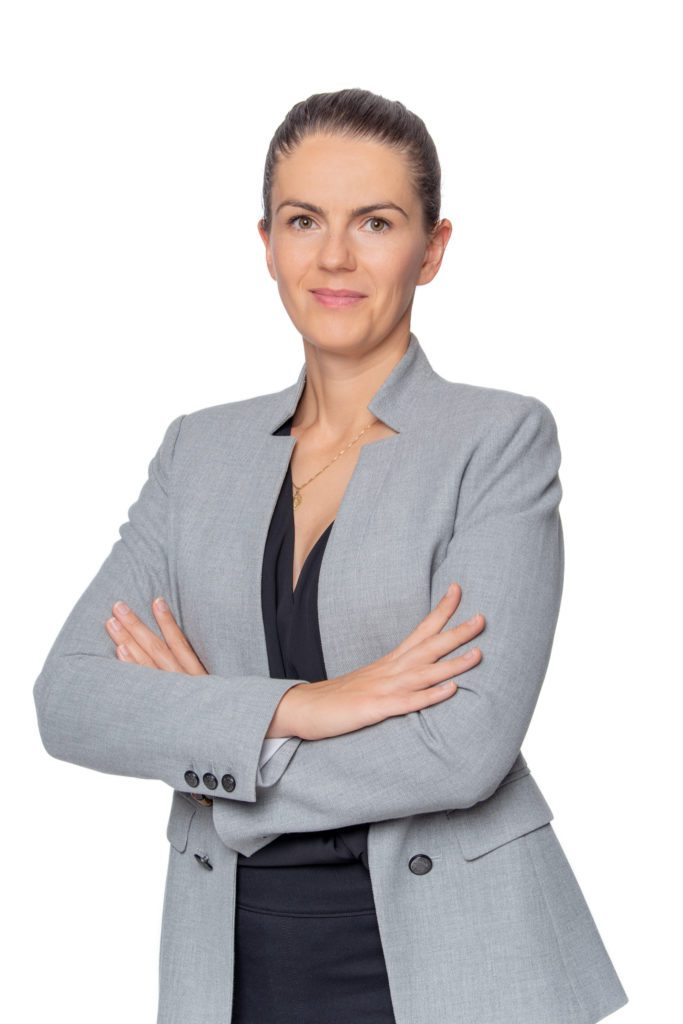 A professional headshot with a white backdrop of a female bookkeeper.
