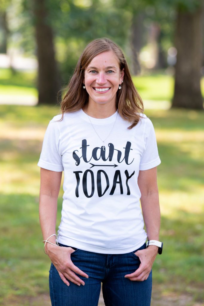 A casual headshot of a female career coach at a park wearing a "Start Today" white t-shirt.