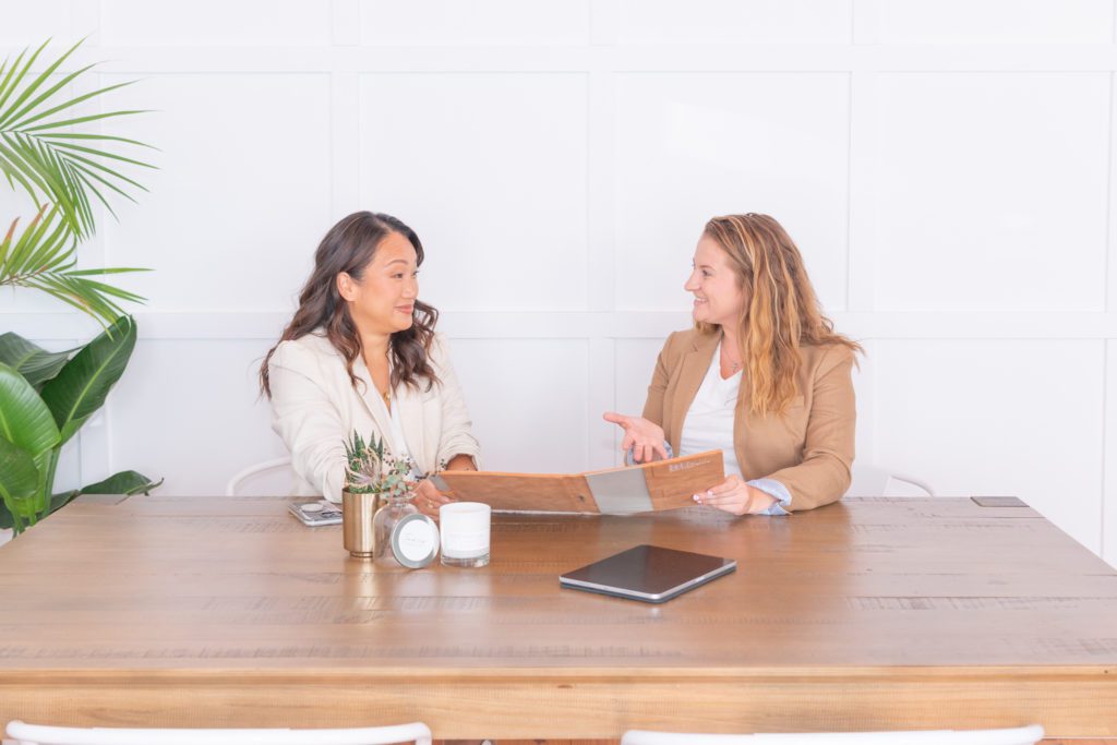 A female financial advisor is having a meeting with her client in a conference room.