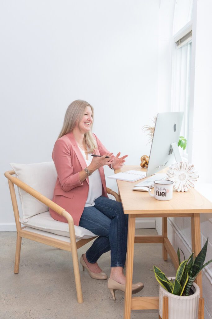 A female business coach doing a video call with her client in her office.