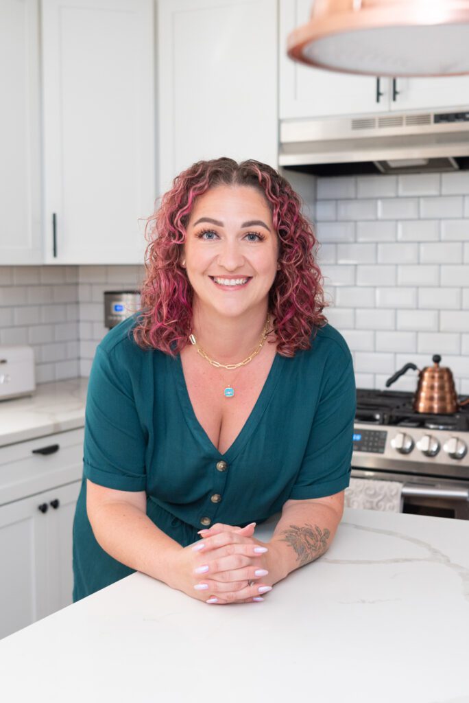 A female New Jersey cottage baker smiling in her home kitchen.