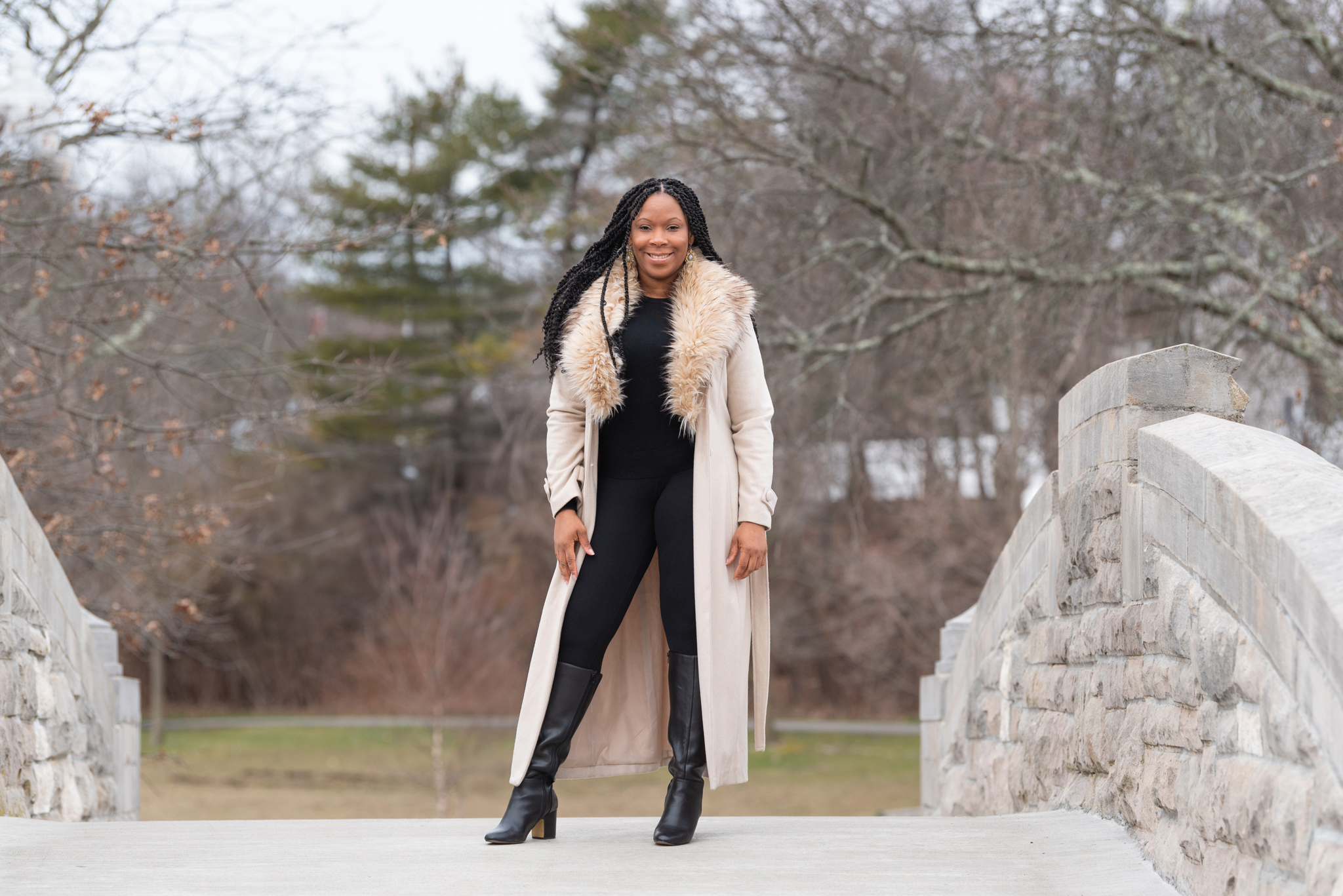 An African American woman standing on a bridge.