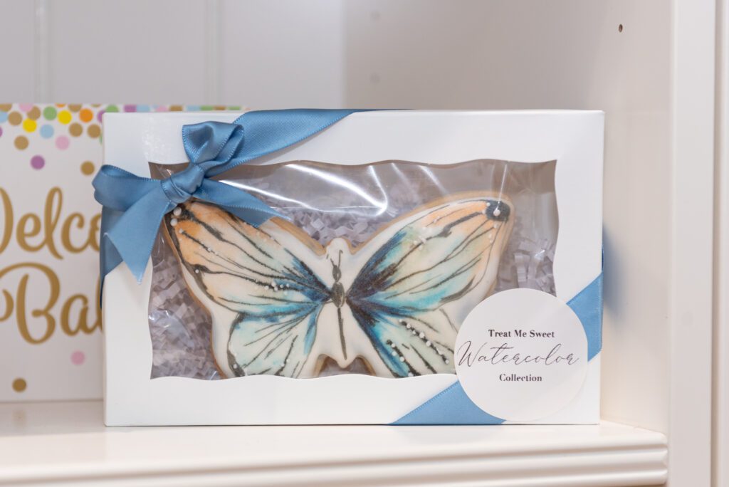 Butterfly painted cookie on the shelf of Treat Me Sweet Cookies in Ridgewood, New Jersey.