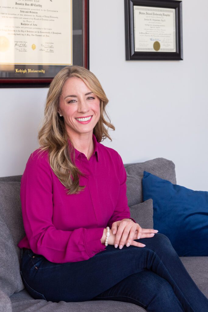 A female psychologist sitting on a couch in her office.