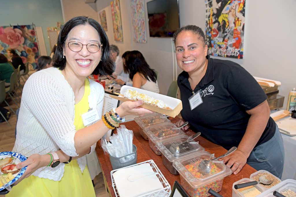 The owner of Waffles & Dreams serving up delicious waffles to the attendees at the Canvas & Connections: Celebrating Women Business Owners event at Moda Studio in Fairfield, NJ.