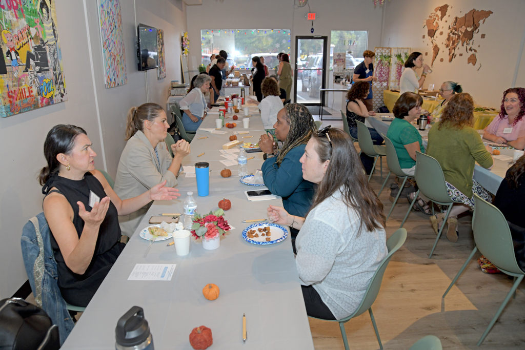 The attendees at the Canvas & Connections: Celebrating Women Business Owners event are enjoying brunch while networking at Moda Studio in Fairfield, NJ.