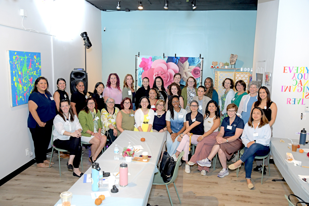 A group of women business owners celebrating at the Canvas & Connections: Celebrating Women Business Owners event at Moda Studio in Fairfield, NJ.