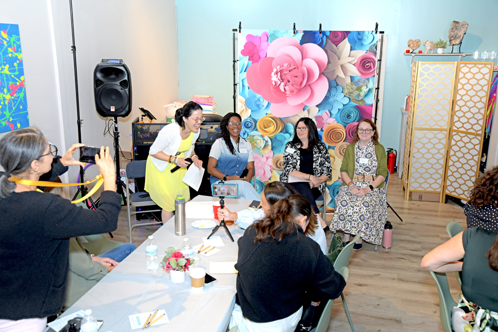 Three panelists and a moderator are laughing during the panel discussion at Canvas & Connections: Celebrating Women Business Owners event at Moda Studio in Fairfield, NJ.