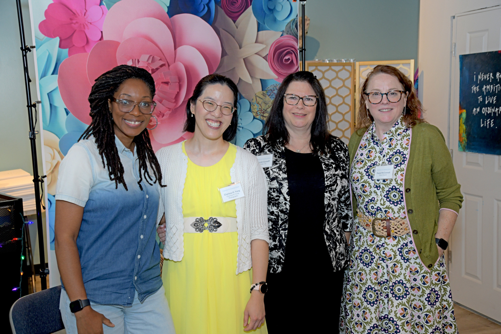 Canvas & Connections: Celebrating Women Business Owners event - networking, panel discussion, paint & sip. The host with 3 panelists smiling for a photo after the panel discussion.