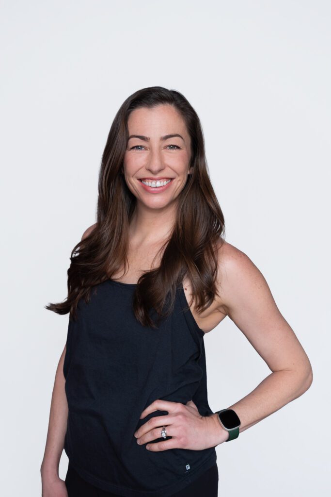 A female Pure Barre franchise owner smiling and posing for her headshot.