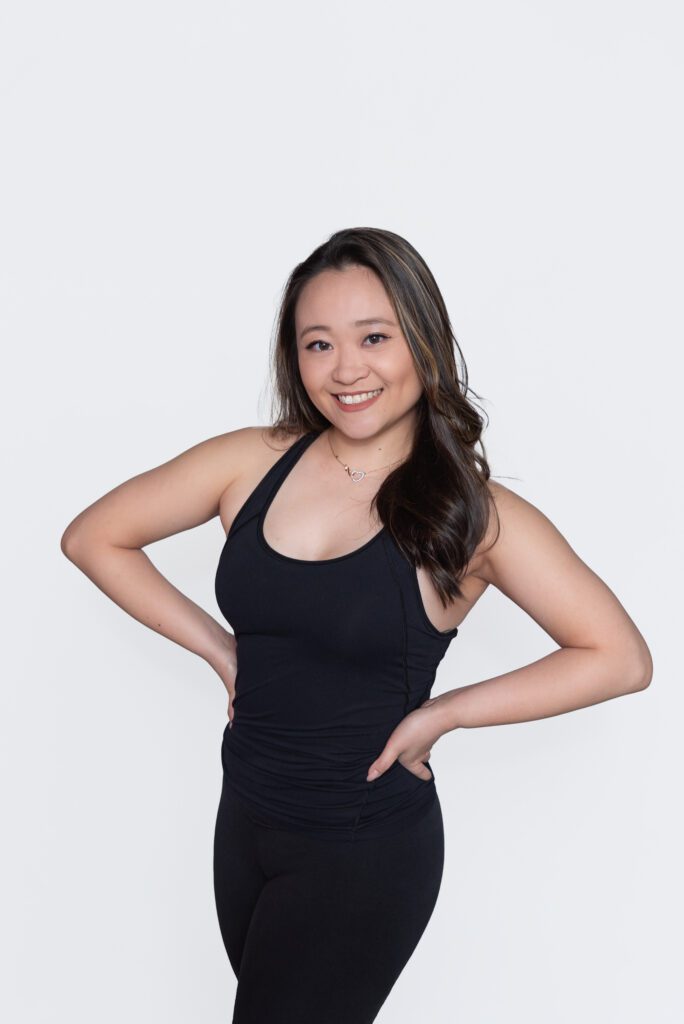A female Pure Barre instructor smiling and posing for her headshot.
