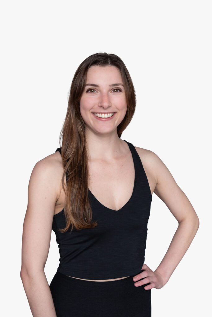 A female Pure Barre instructor smiling and posing for her headshot.