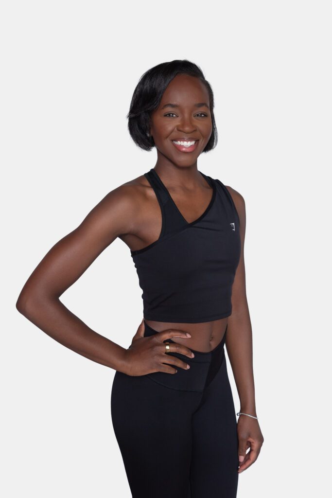 A female Pure Barre instructor smiling and posing for her headshot.