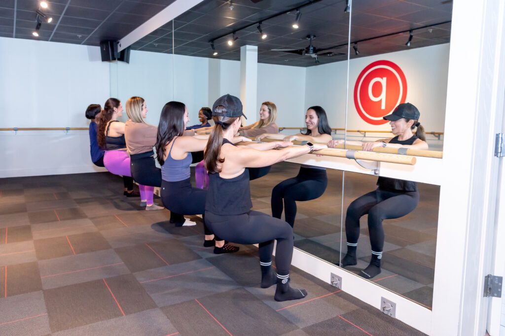 A group of ladies working out at a Pure Barre studio.