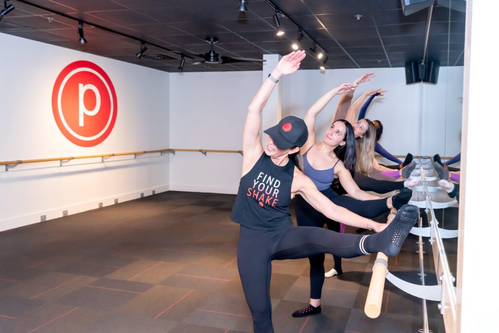 A group of ladies working out at a Pure Barre studio.