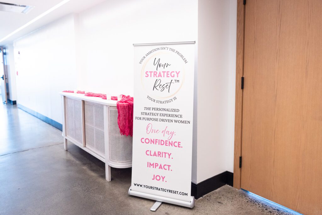 Your Strategy Reset event sign in the hallway of the Wave Resort event space.