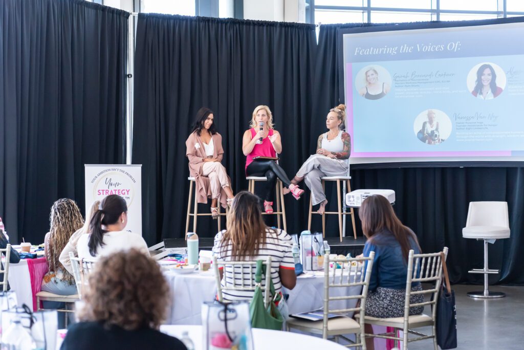 Three female panelist on the stage at the Your Strategy Reset event in the Wave Resort.