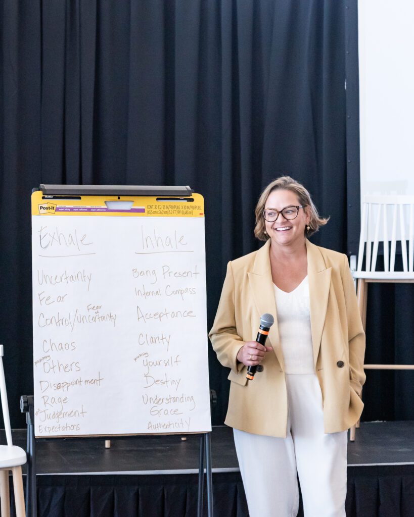 An attendee holding a mic and talking at the Your Strategy Reset event in the Wave Resort.