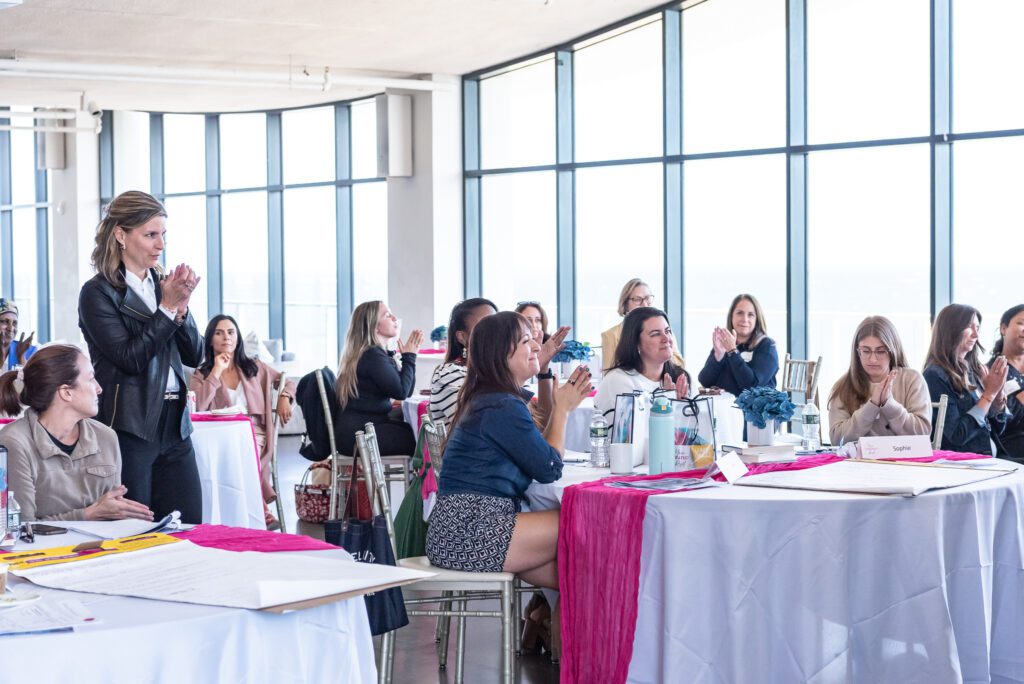 Attendees clapping at the Your Strategy Reset event in the Wave Resort.