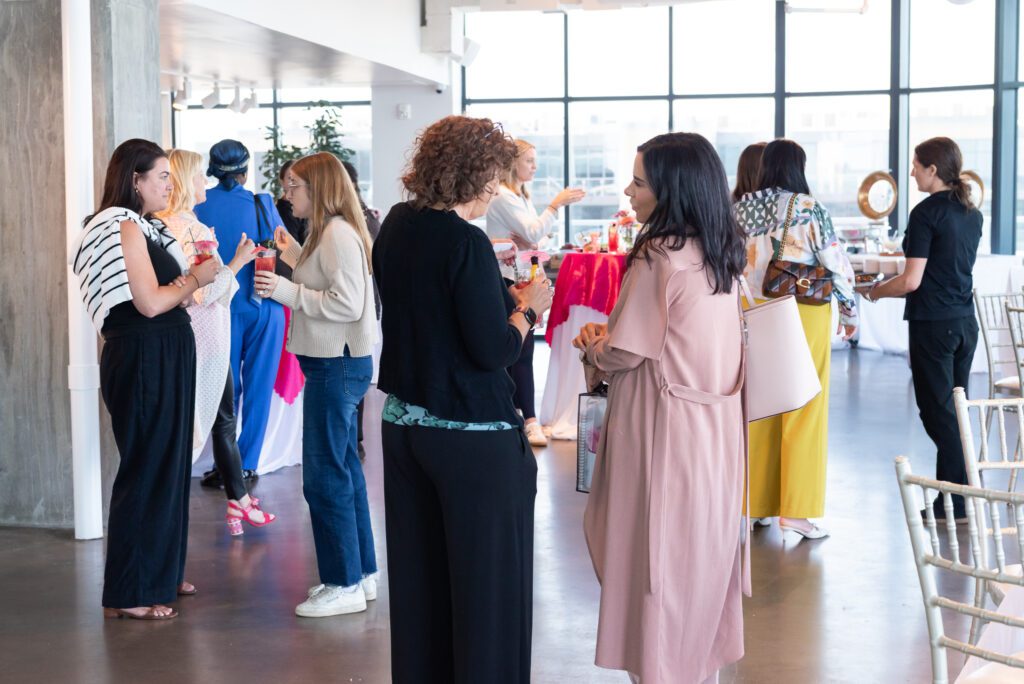 Attendees conversing with each other while enjoying mocktails and food at the Your Strategy Reset event in the Wave Resort.