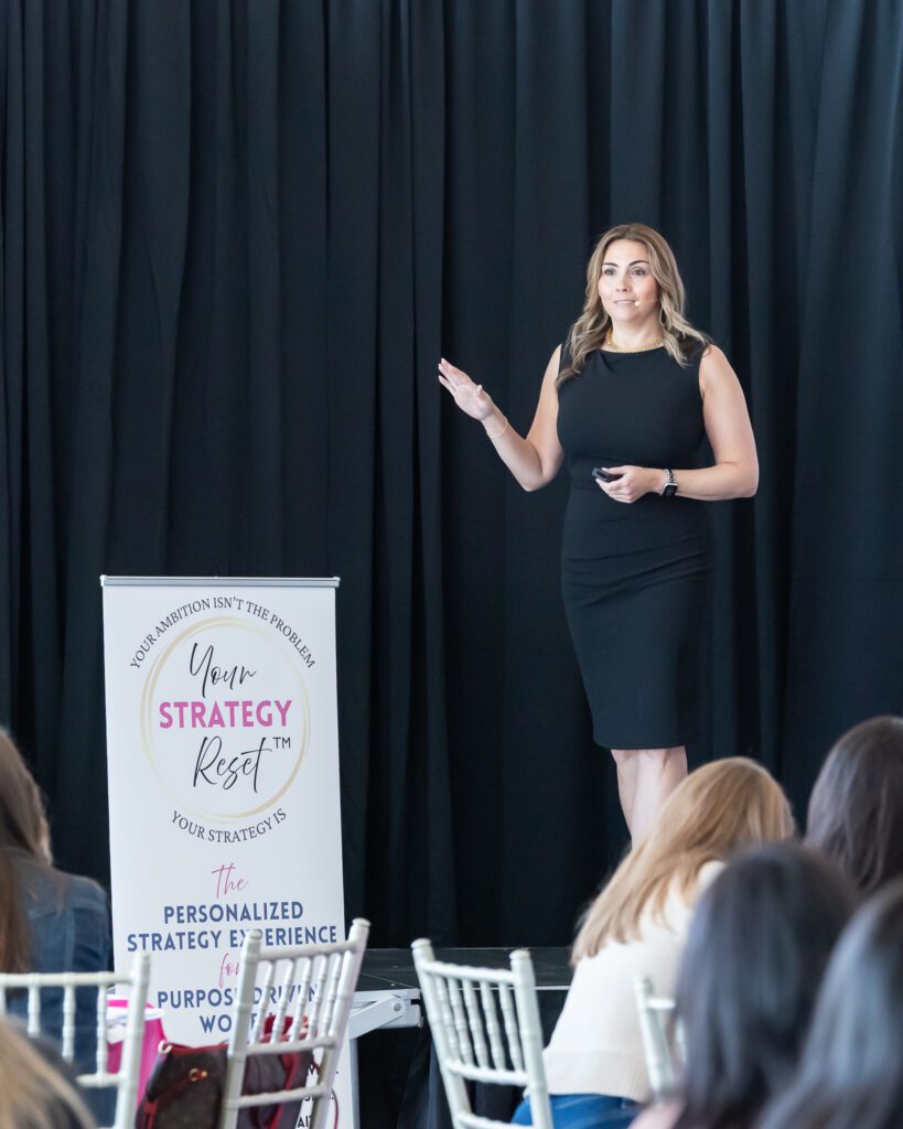 An empowerment coach and host speaking at the Your Strategy Reset event in the Wave Resort.