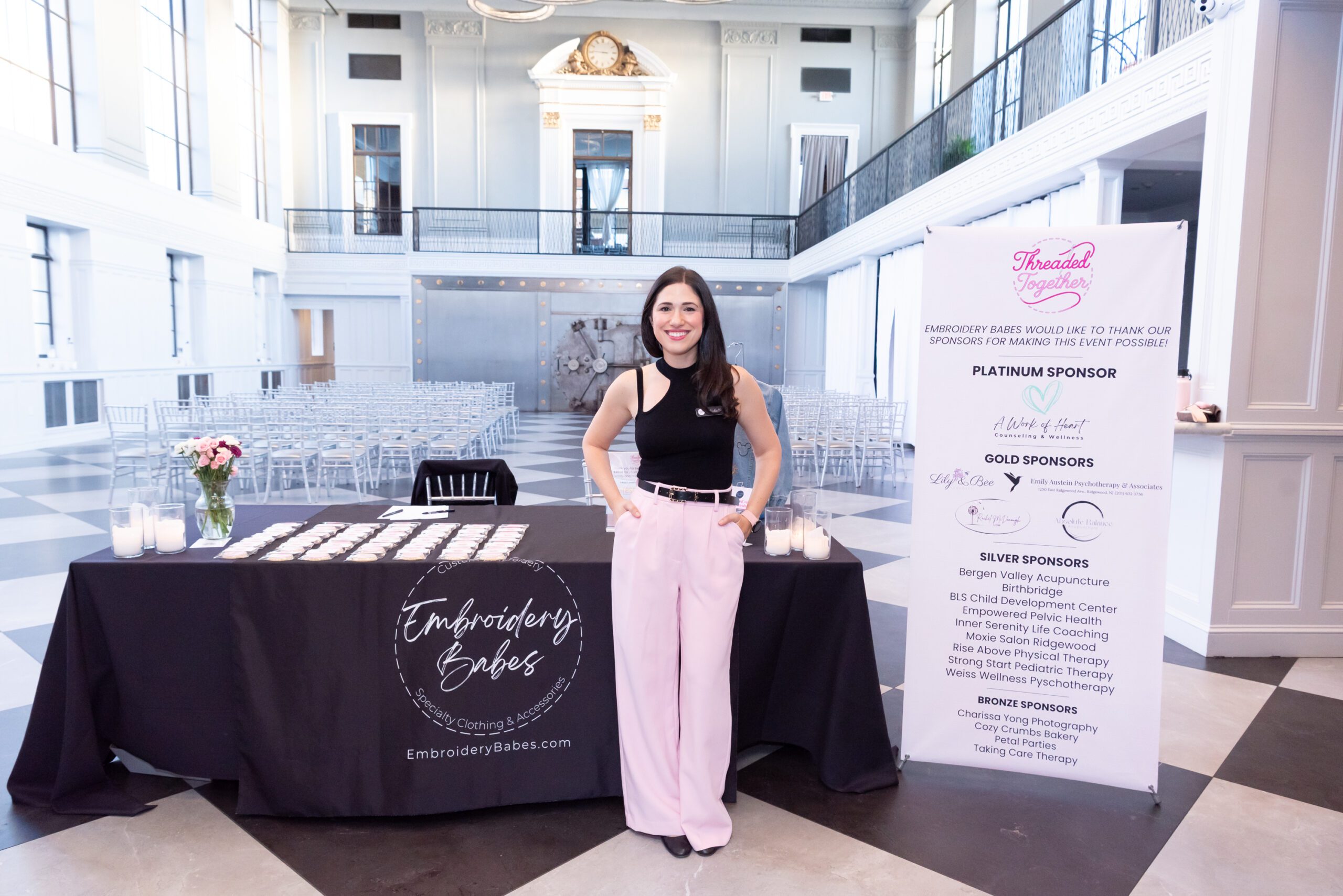 The female owner and host of the embroidery workshop posing and smiling at her event.