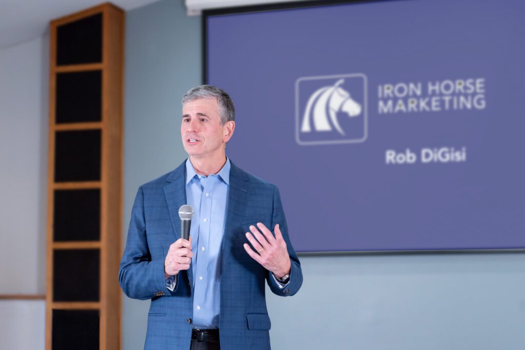 A male public speaker talking on the stage.