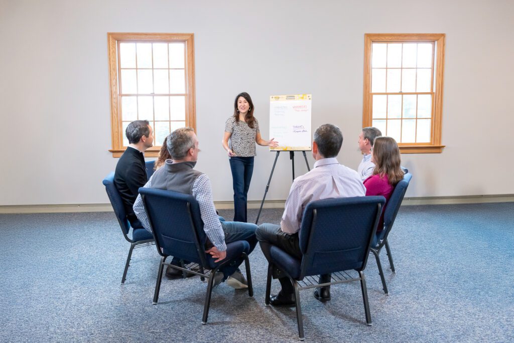 A female Asian executive coach & advisor facilitating a workshop.