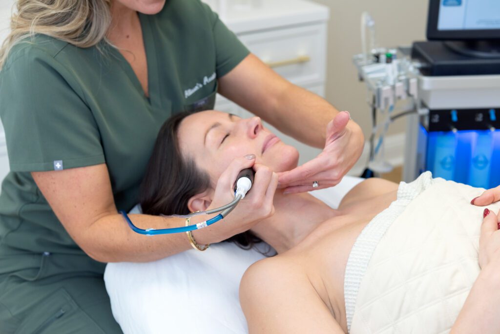 A female getting a Hydrafacial treatment.