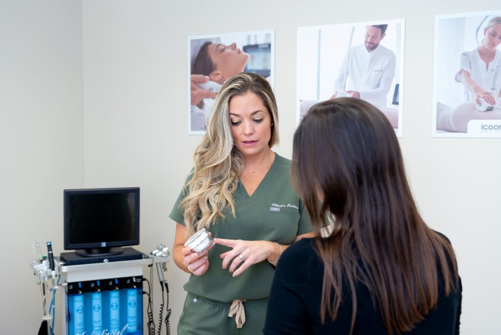 A female aesthetician showing and recommend a product for her client.